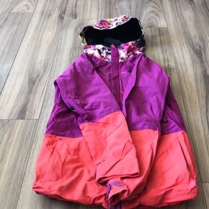 The brand is Burton and the colours are pink and purple